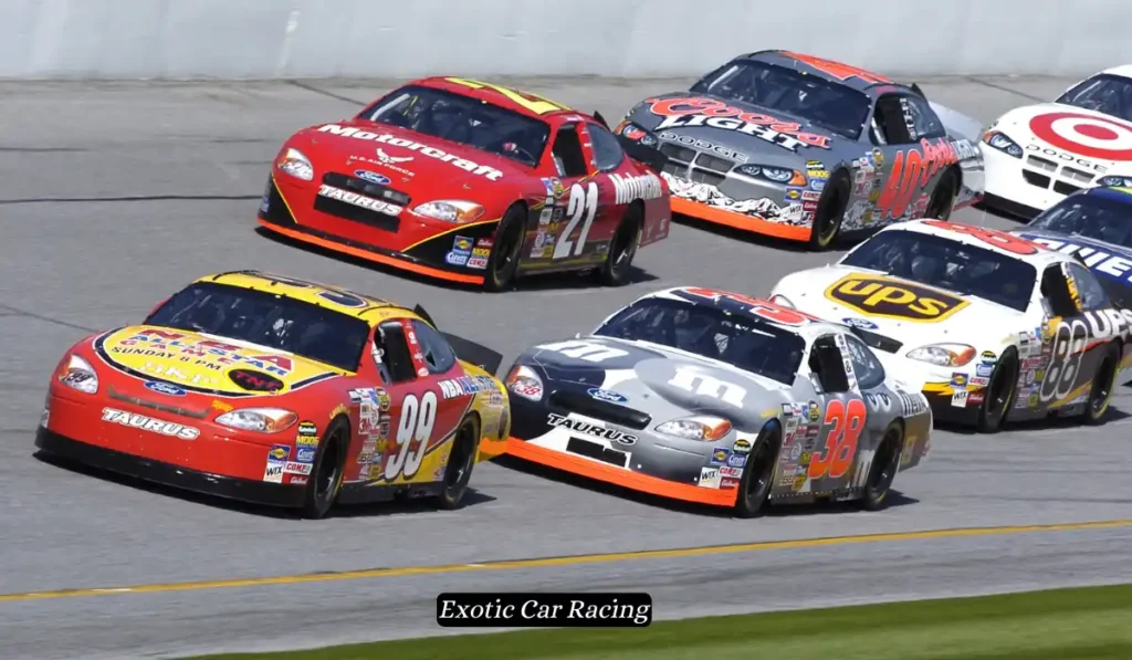 Race cars speed around a track, closely competing in a NASCAR race. Cars display various colorful sponsors and numbers, including 92, 21, 38, and more, as they navigate a curved section of the circuit. Crowd barriers and a blurred background add to the sense of motion.
