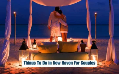 A couple stands embraced under a canopy on a beach at night, surrounded by lit lanterns. There is a cozy setting with cushions and a table. The scene is romantic and serene. Text at the bottom reads, "Things To Do in New Haven For Couples.