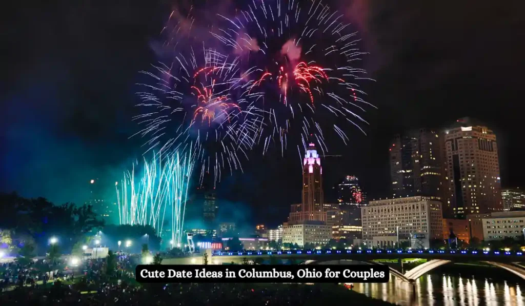 Fireworks light up the night sky over a cityscape in Columbus, Ohio, with illuminated buildings and a bridge. The text reads, "Cute Date Ideas in Columbus, Ohio for Couples.
