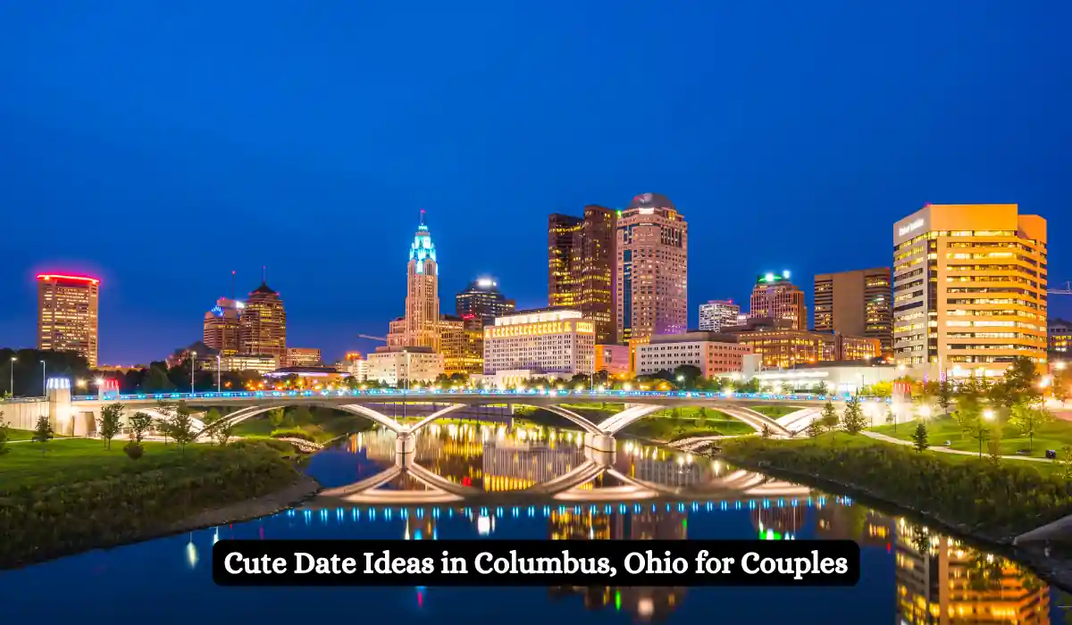 City skyline of Columbus, Ohio, at dusk with illuminated buildings and a bridge reflecting on the river. Text overlay says, "Cute Date Ideas in Columbus, Ohio for Couples.