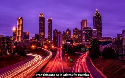 A vibrant, nighttime view of Atlantas skyline with streaking car lights on the highway below. The buildings are illuminated against a purple sky. Text at the bottom reads, Free Things to do in Atlanta for Couples.