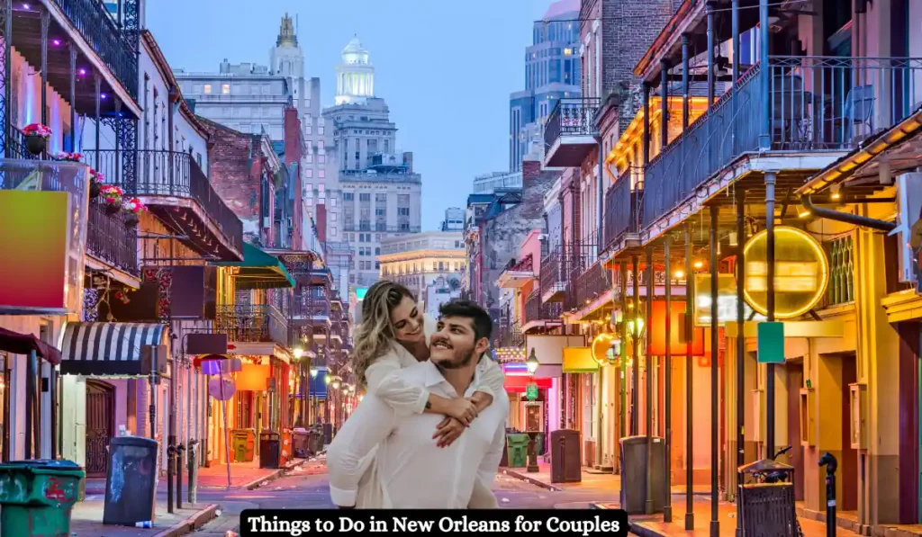 A happy couple is enjoying a piggyback ride on a lively street in New Orleans. The scene features colorful buildings, vibrant lights, and a backdrop of tall city structures, creating a romantic, energetic atmosphere. Text reads, Things to Do in New Orleans for Couples.
