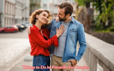 A smiling couple embraces while walking in a city street. The woman wears a red blouse and jeans, and the man wears a denim shirt and khakis. Text at the bottom reads, Things to Do in Pocatello for Couples.